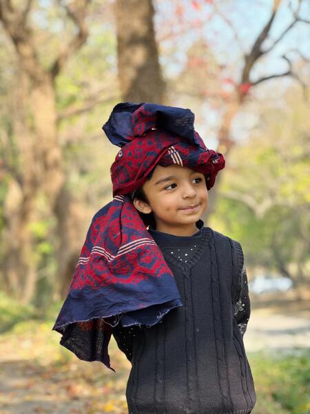 kid wearing ajrak shawl
