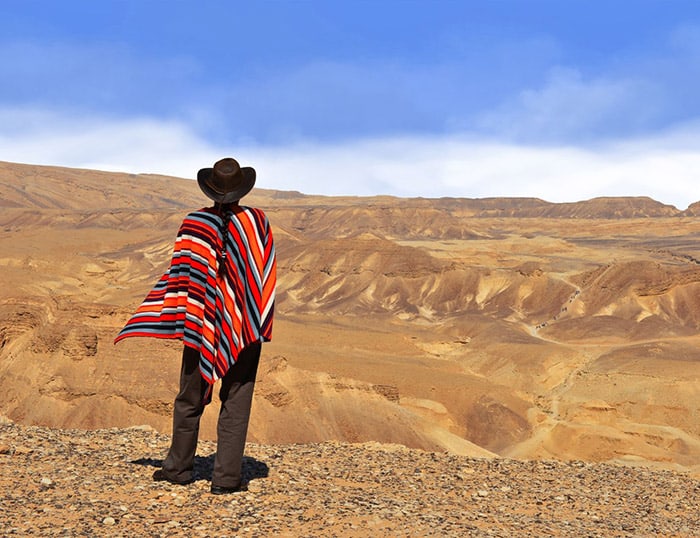 men-wearing-poncho-in-the-desert