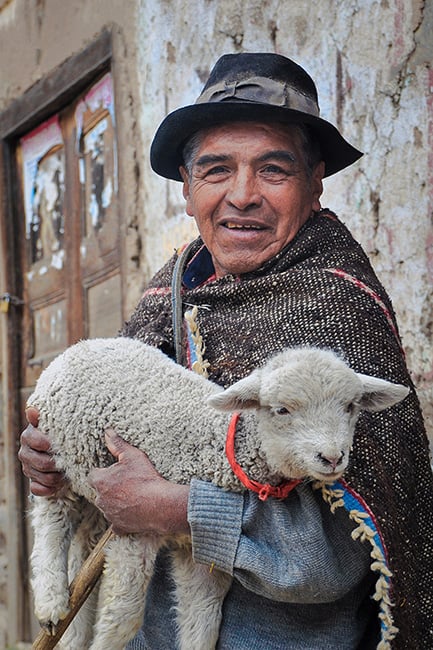 traditional-men-wearing-poncho-and-holding-lamb